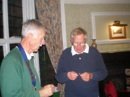 John Wilson admiring his 30 year lapel badge