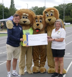 Lion orgnaiser Penny prenseting the cheque to Activity Alloance officials Lion orgnaiser Penny prenseting the cheque to Activity Alloance officials